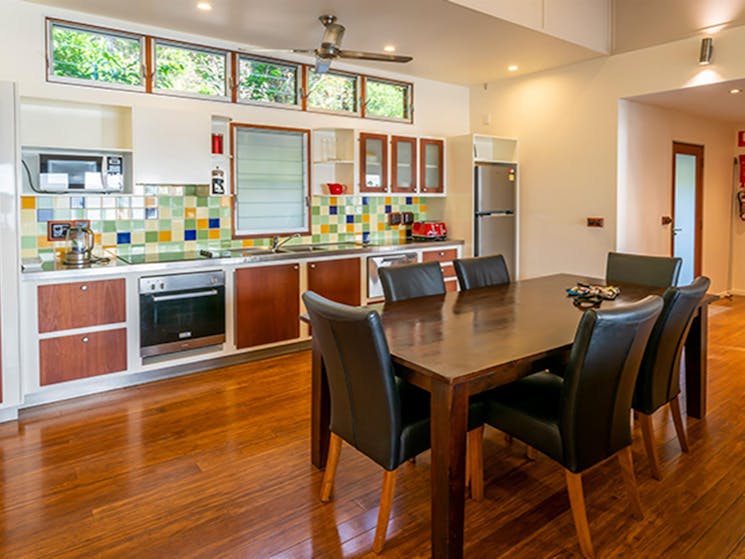 A colourful kitchen and large dining table at Mildenhall cottage. Photo: DPIE/John Spencer