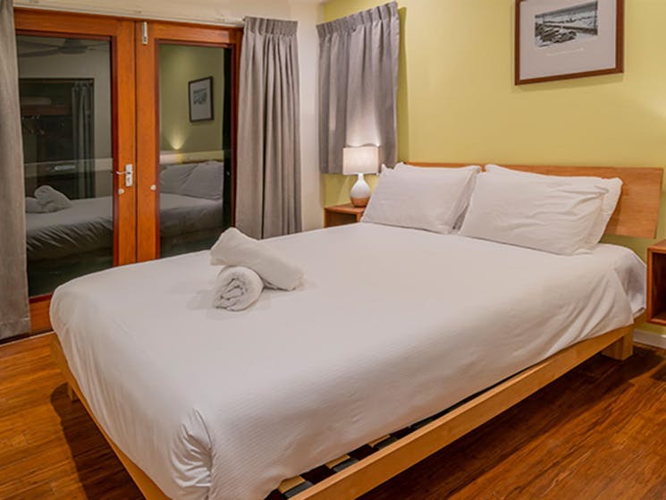 Clean, large bedroom with a queen bed with  Mildenhall cottage. Photo: DPIE/John Spencer