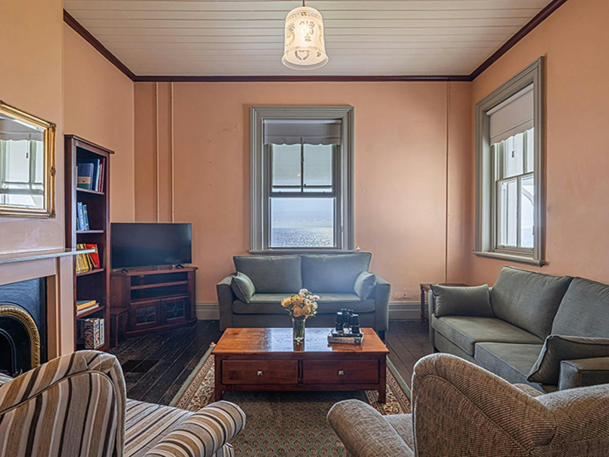 Lounge chairs and gas fire in the lounge room at Montague Island Assistant Lighthouse Keeper's