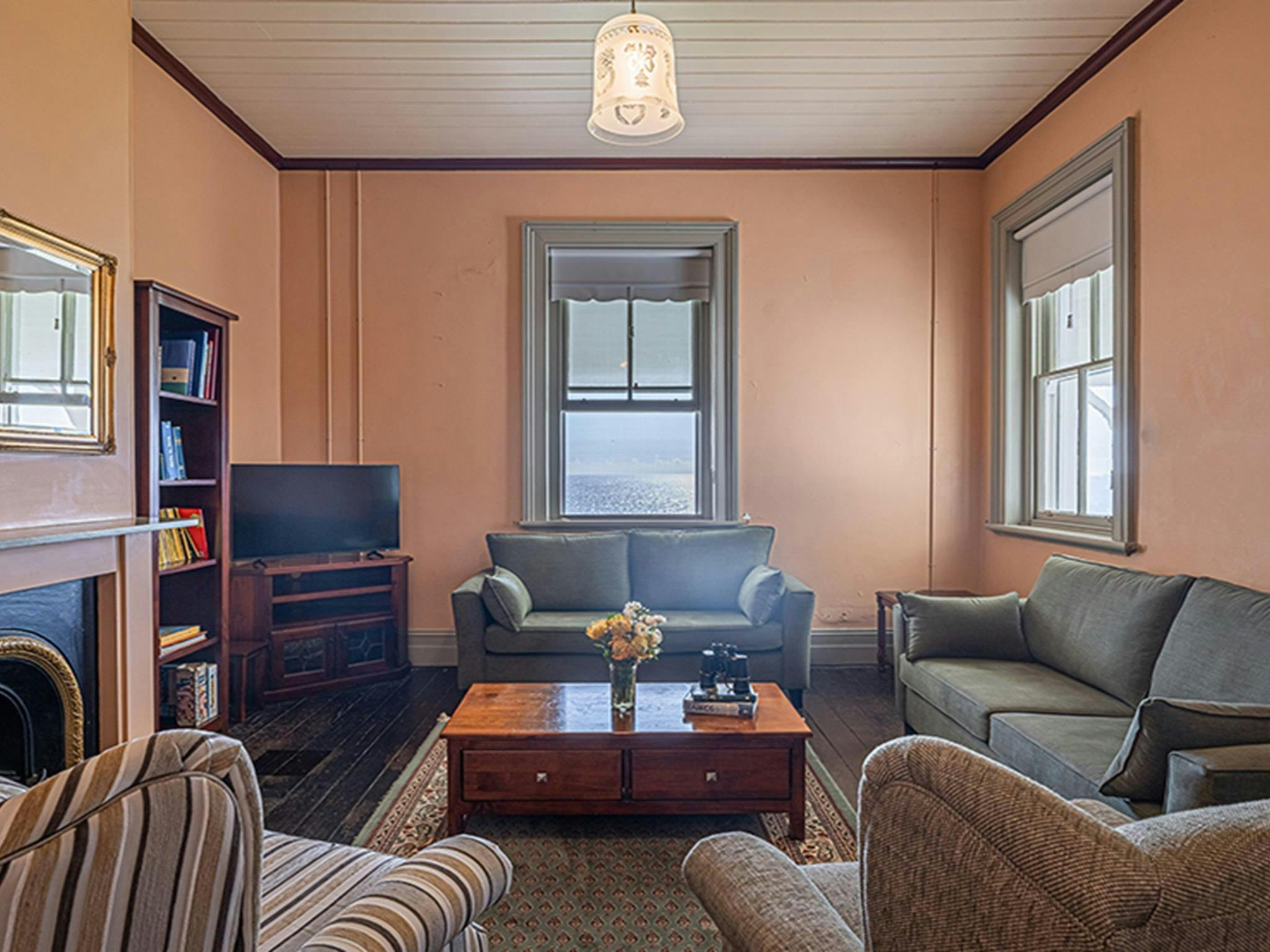 Lounge chairs and gas fire in the lounge room at Montague Island Assistant Lighthouse Keeper's