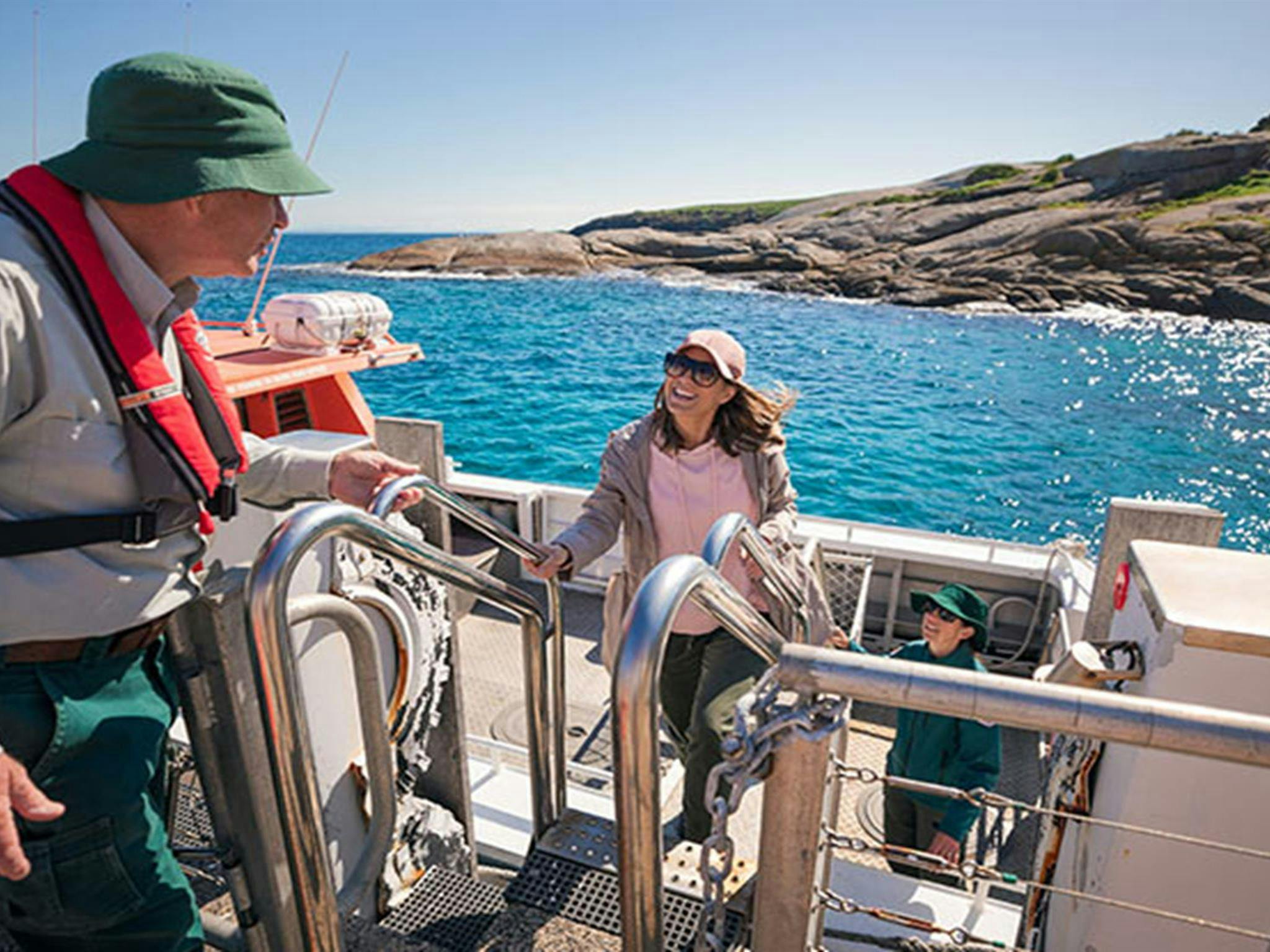 A woman disembarks a boat on arrival at Barunguba Montague Island Nature Reserve. Photo: Daniel