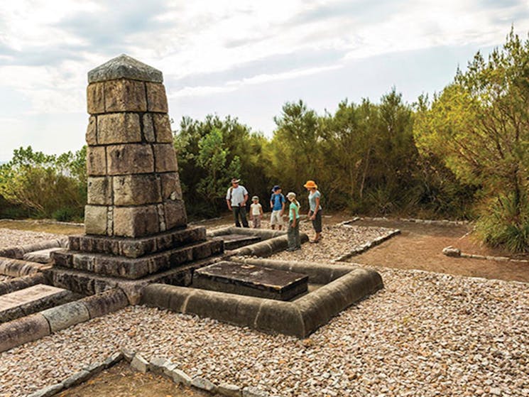 Visitors standing by the monument tribute at Arakoon National Park. Photo: David Finnegan/DPIE