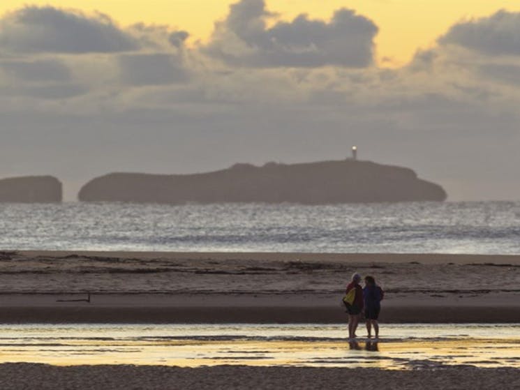 A couple on the shores of Moonee Creek in Moonee Beach Nature Reserve. Photo: Rob Clear &copy; OEH