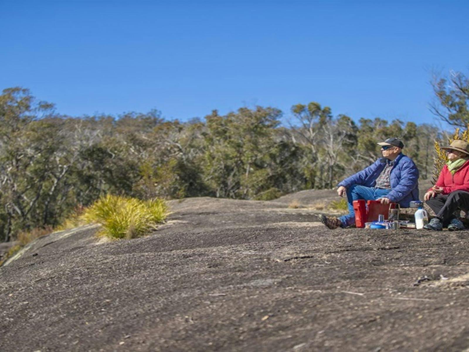 Visitors sitting on the granite rock formations at Morgans Gully picnic area. Photo: Joshua J ©