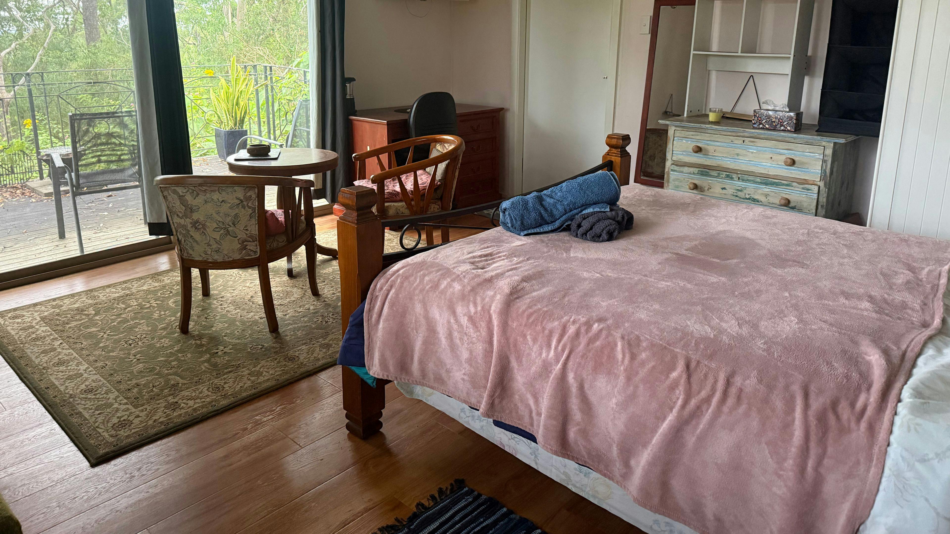 Comfy queen-size bed in open plan bed-living room.