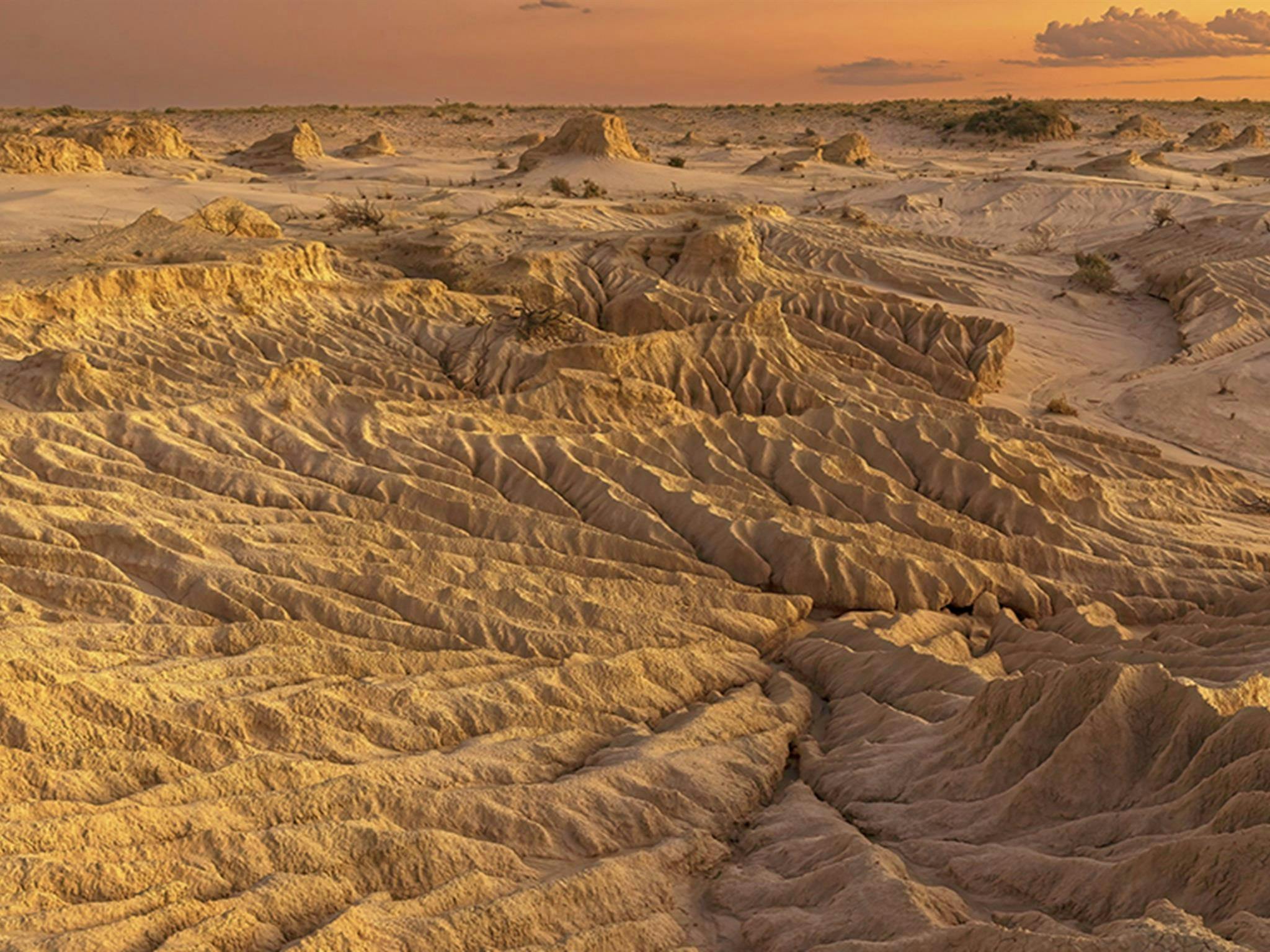 Aerial view of Mungo lunette formations in a golden landscape at sunset. Credit: Hao Li/DCCEEW