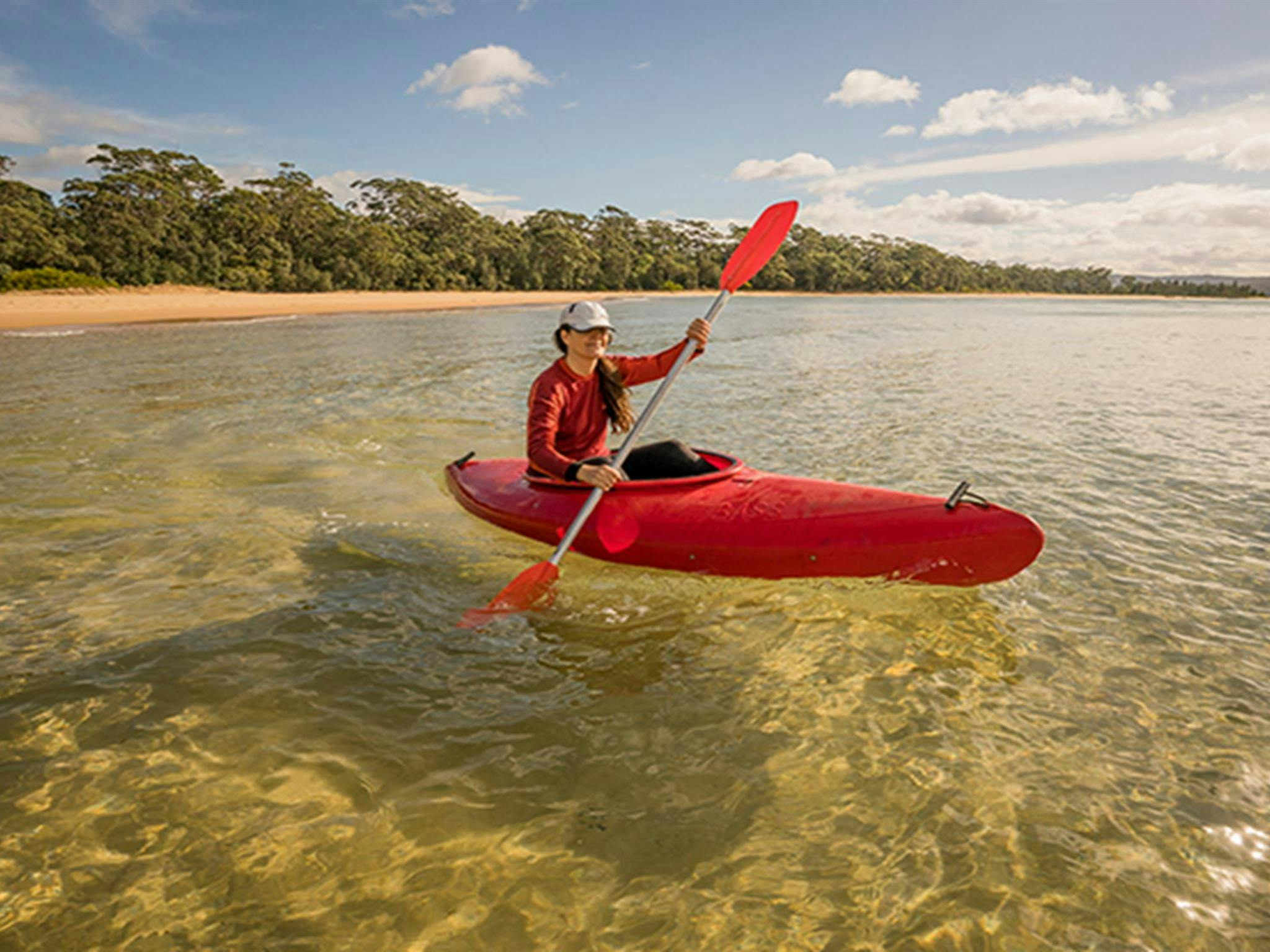 Woman in kayak at Bithry Inlet,at  the mouth of Wapengo Lake. Photo: OEH/John Spencer