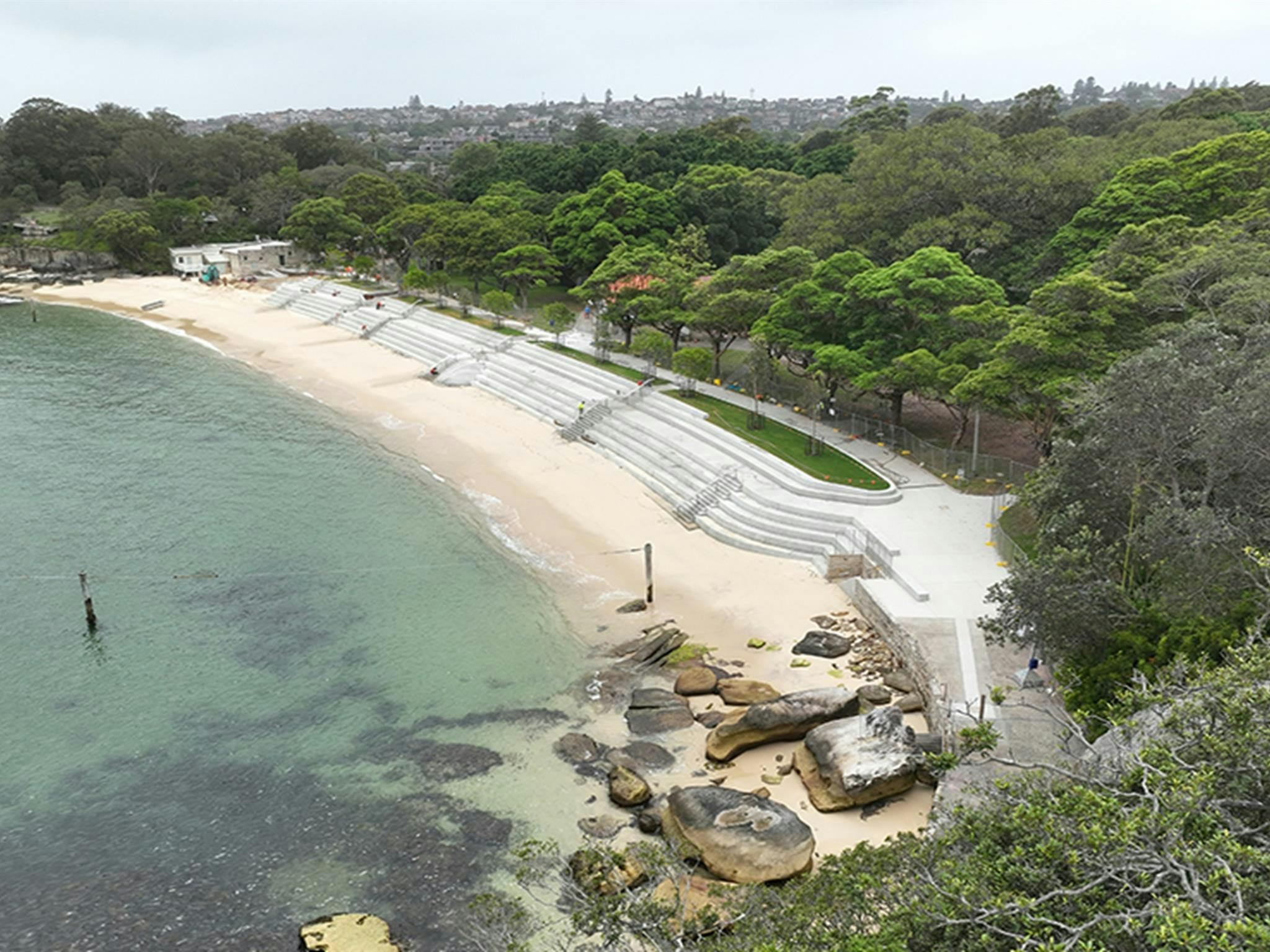Aerial photo of Nielsen Park showing the concrete seawall and Shark Beach and bordering lush green