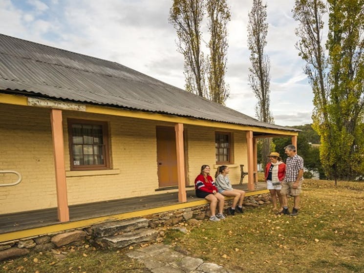 Family on the porch at Old Trahlee. Photo: John Spencer/OEH