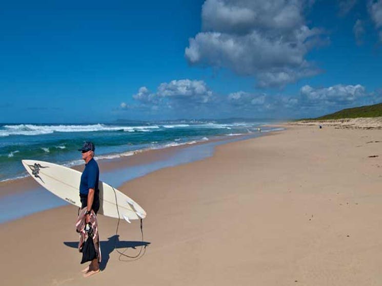 Surfer on Pelican Beach. Photo: John Spencer