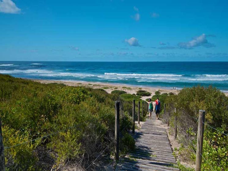 Two people on the track to Pelican Beach. Photo: John Spencer