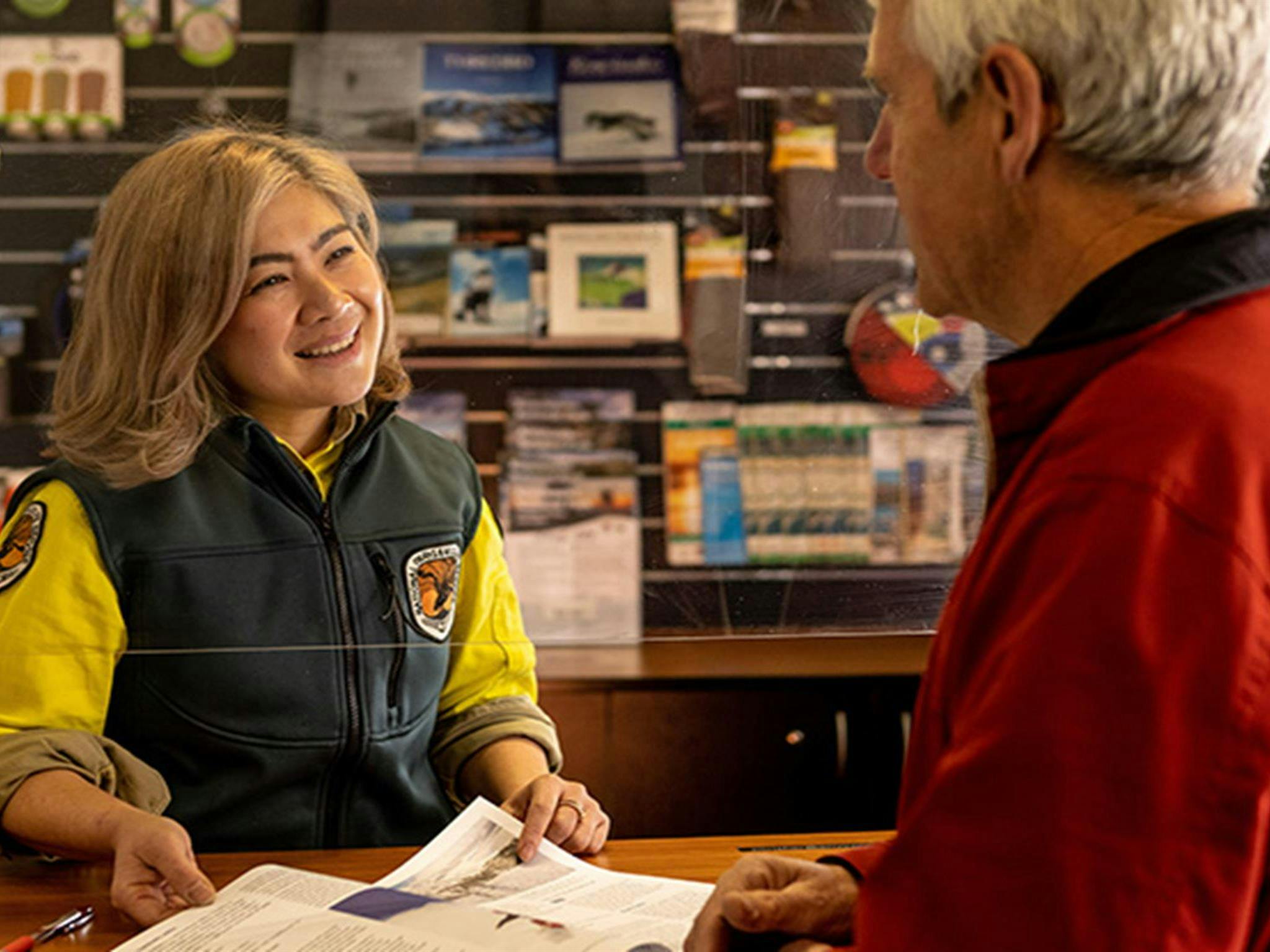 National Parks staff assisting a visitor at Perisher Valley Office, in Kosciuszko National Park.