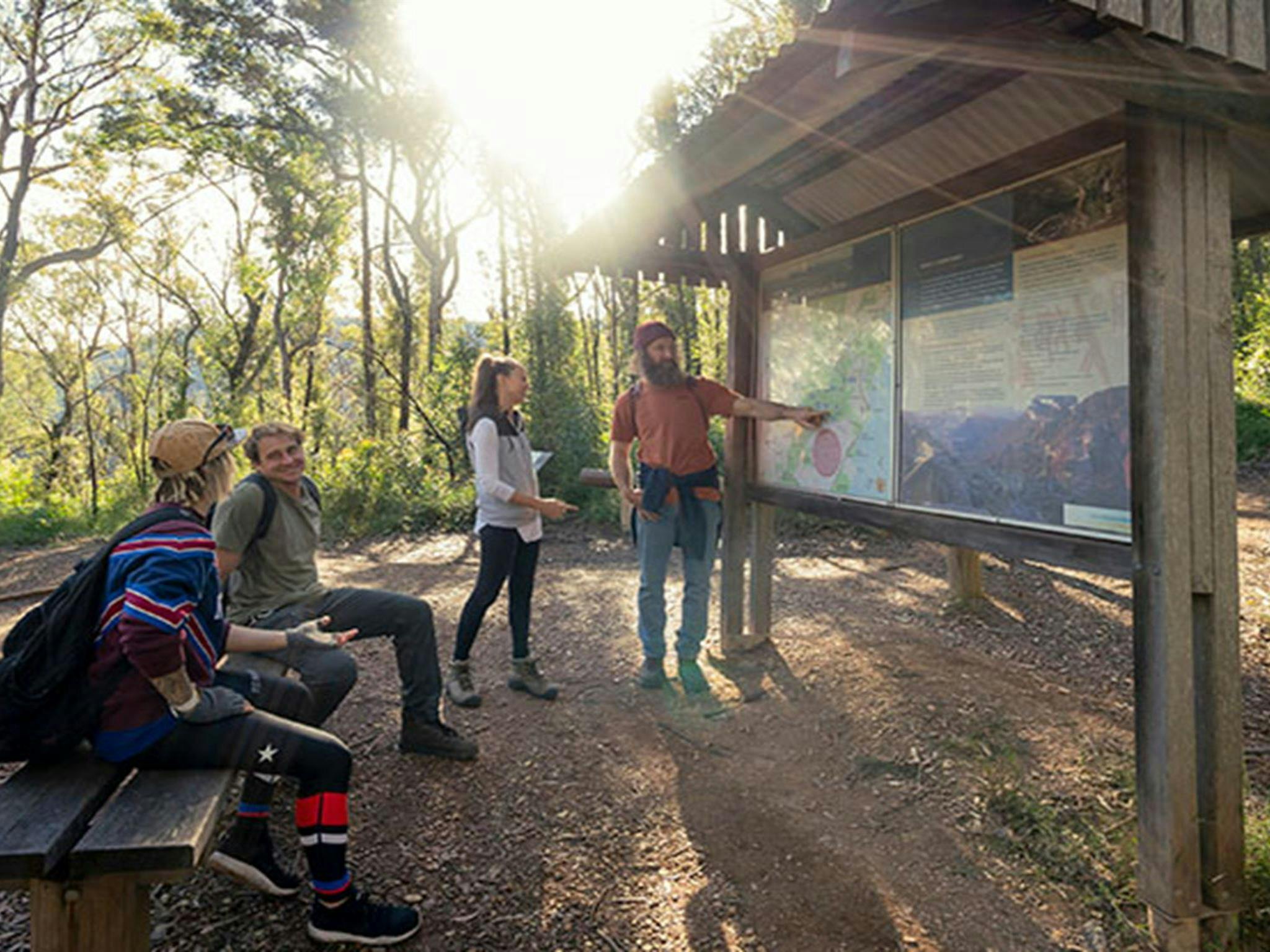 People looking at the interpretive signage, Pigeon House Mountain Didthul picnic area, Morton