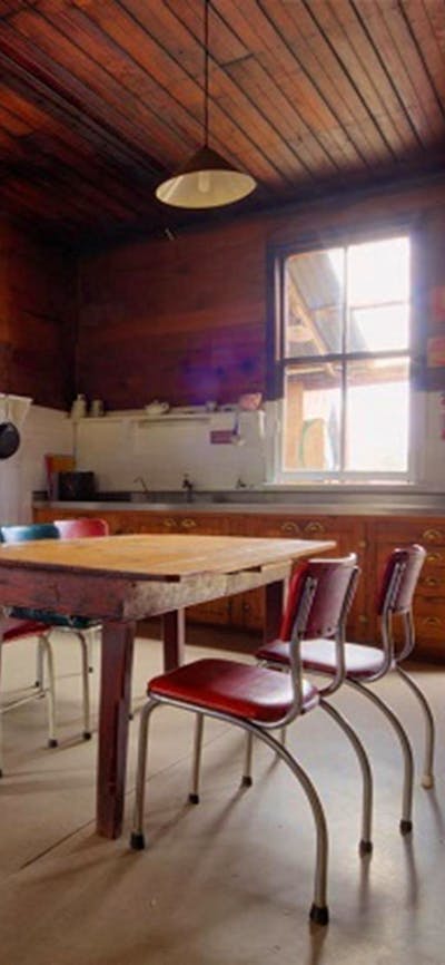 Kitchen and dining area in The Pines Cottage, Kosciuszko National Park. Photo: Murray Vanderveer/OEH