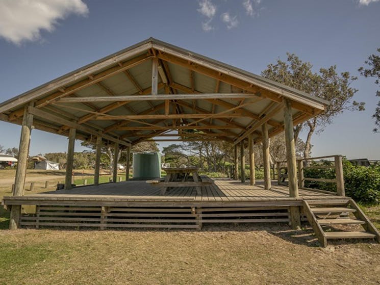 Picnic tables with large shelter at Point Plomer campground, Limeburners Creek National Park. Photo:
