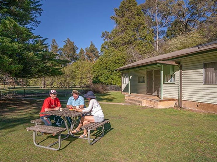 Family picnic at Post Office Cottage at Wombeyan Caves. Photo: OEH/John Spencer