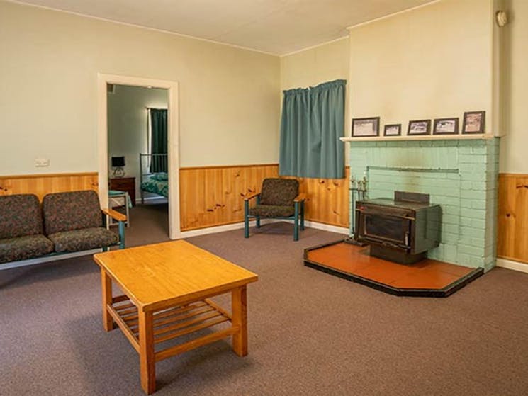 Lounge room at Post Office Cottage, including a wood fire. Photo: OEH/John Spencer