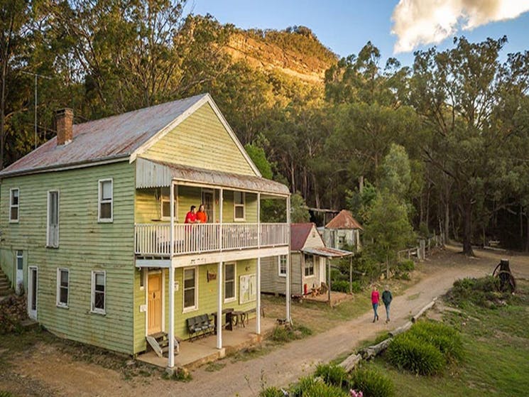 Friends strolling past Post Office Lodge in Yerranderie Private Town, Yerranderie Regional Park.