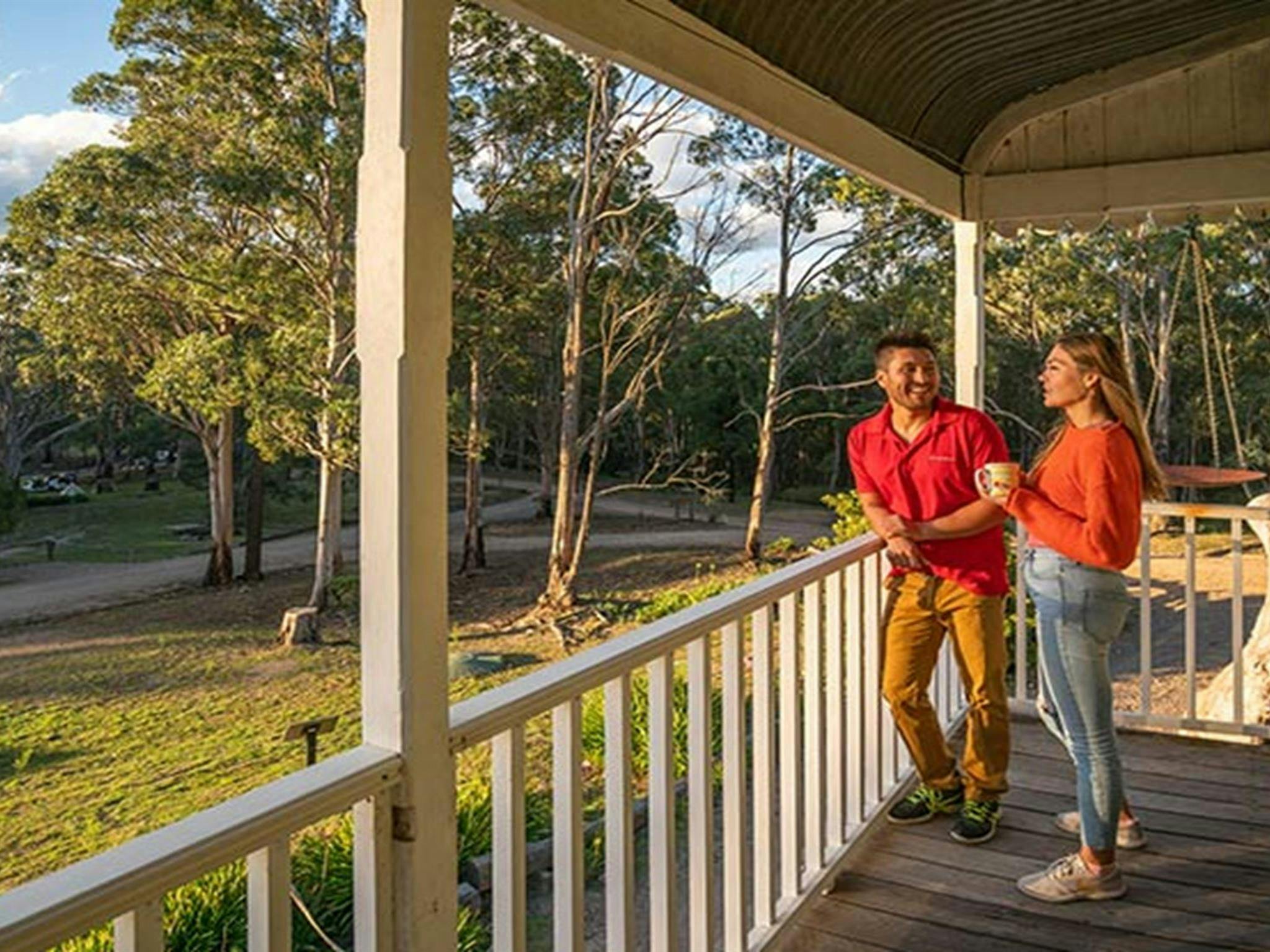 A couple looking out at Yerranderie Private Town from the balcony of Post Office Lodge in