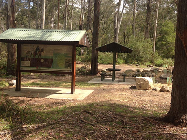 Postmans campground on a sunny day showing visitor information board and picnic shelter. Photo: