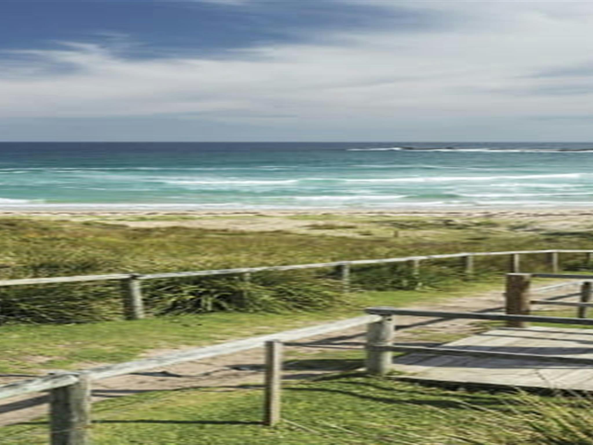 Couple enjoying views over Pretty Beach on the NSW South Coast. Photo credit: David Finnegan