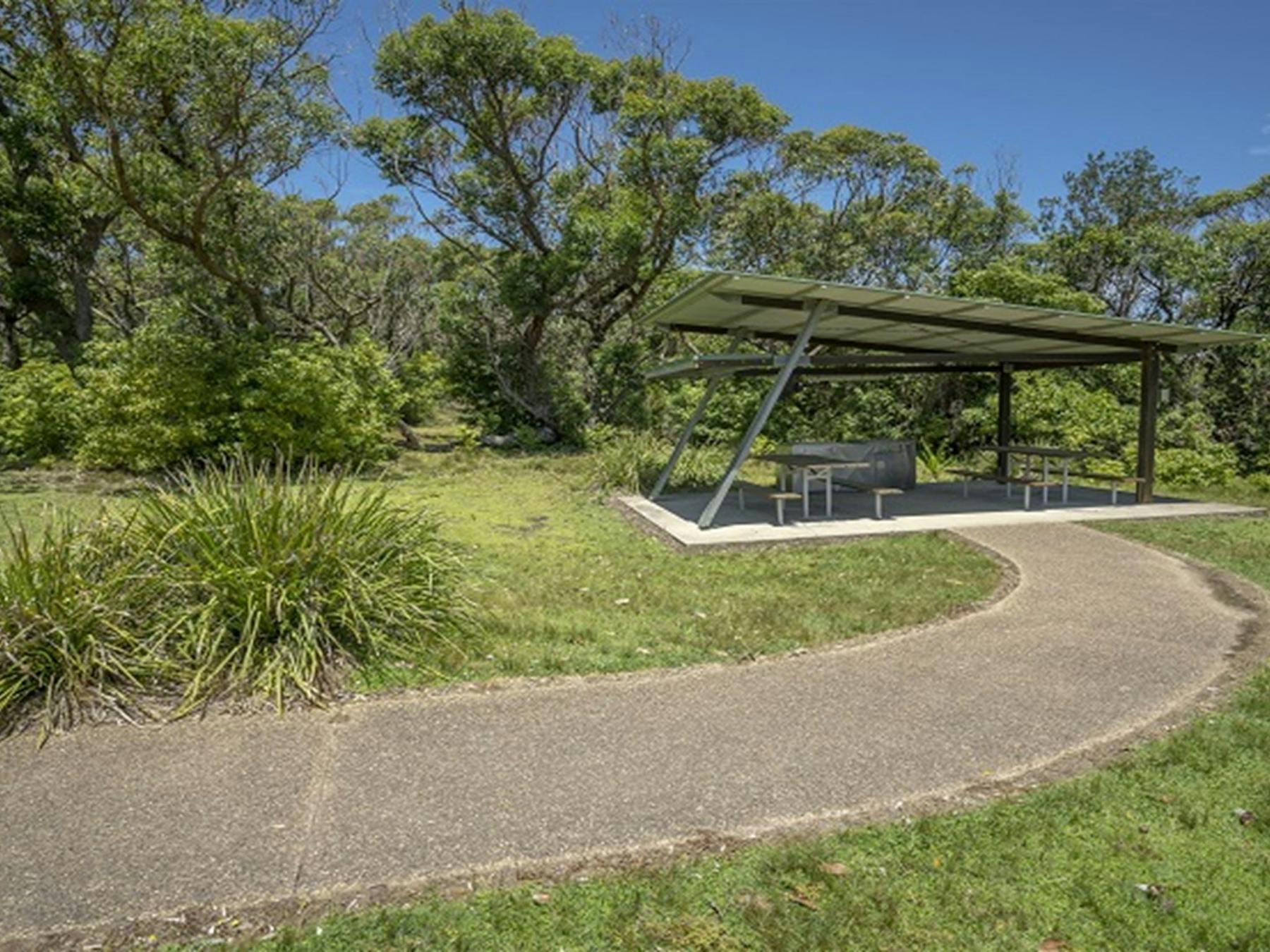 Covered picnic tables at Pretty Beach picnic area. Photo credit: John Spencer © DPIE