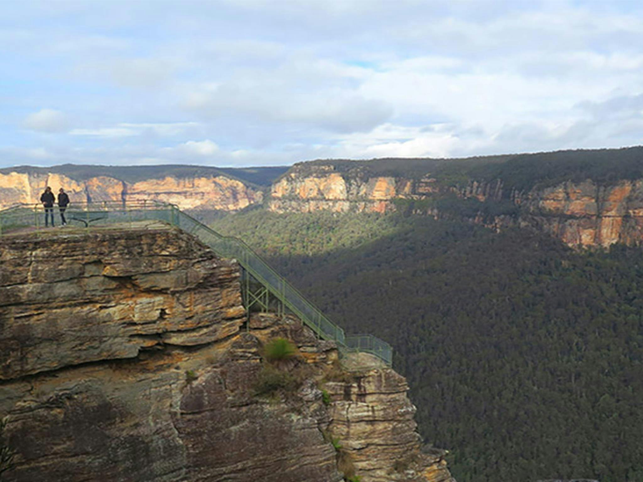 Three people at Pulpit Rock lookout's lower viewpoint, Blue Mountains National Park. Photo: E