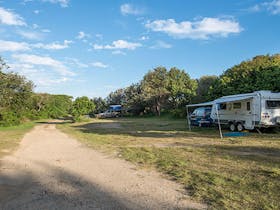 A caravan trailer and car on site at Racecourse campground, Goolawah National Park. Photo: John