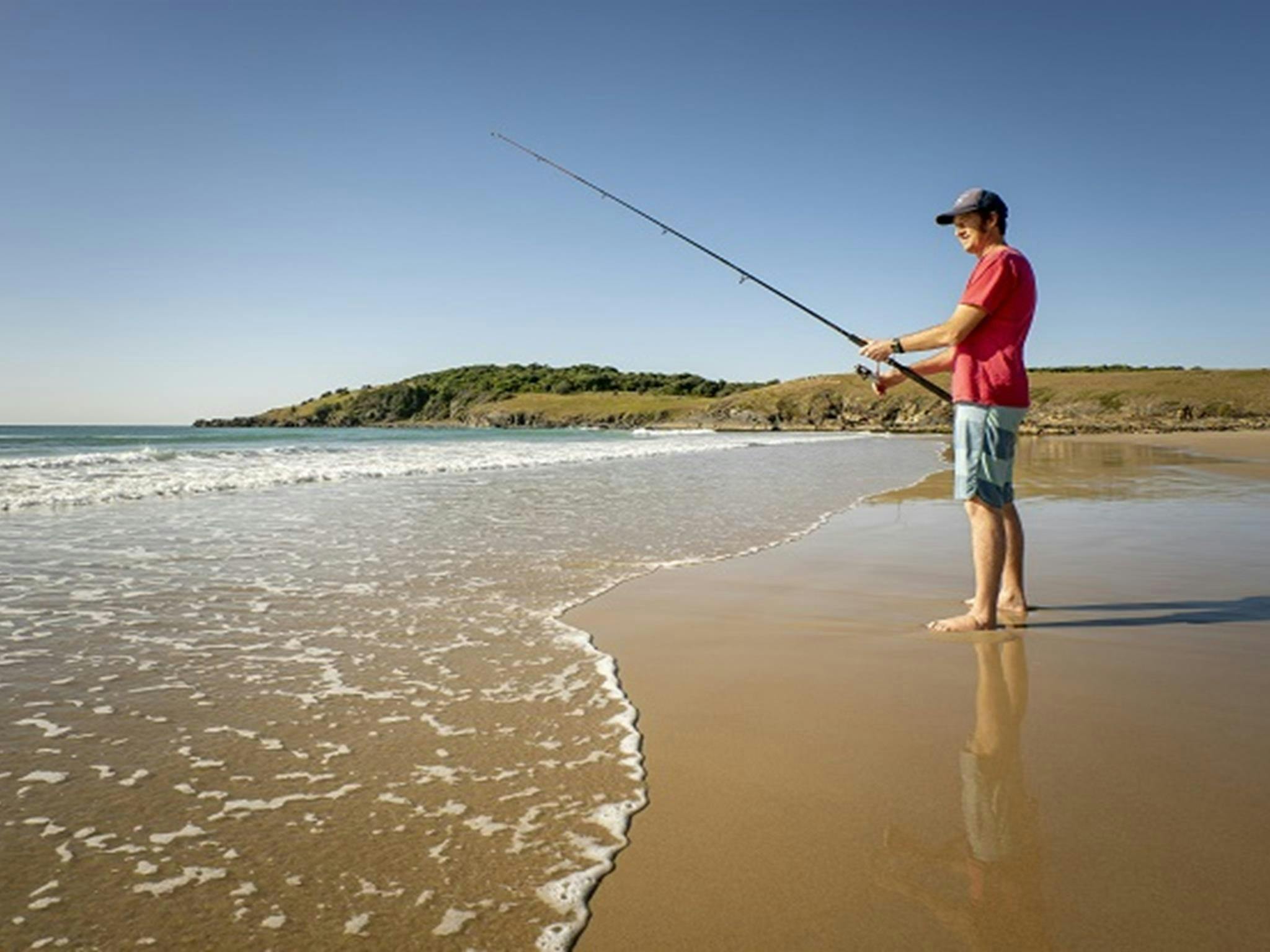 A man on Goolawah beach fishing nearby Racecourse campground, Goolawah National Park. Photo: John