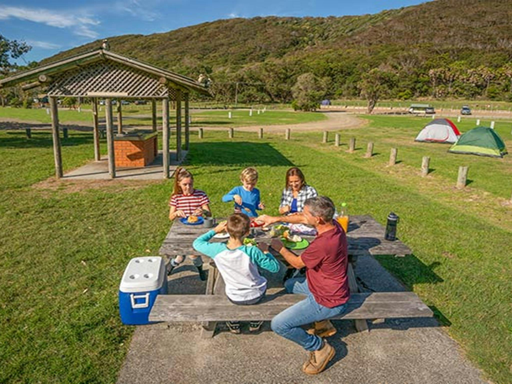 A family enjoys a barbecue lunch at The Ruins campground and picnic area. Photo credit: John Spencer