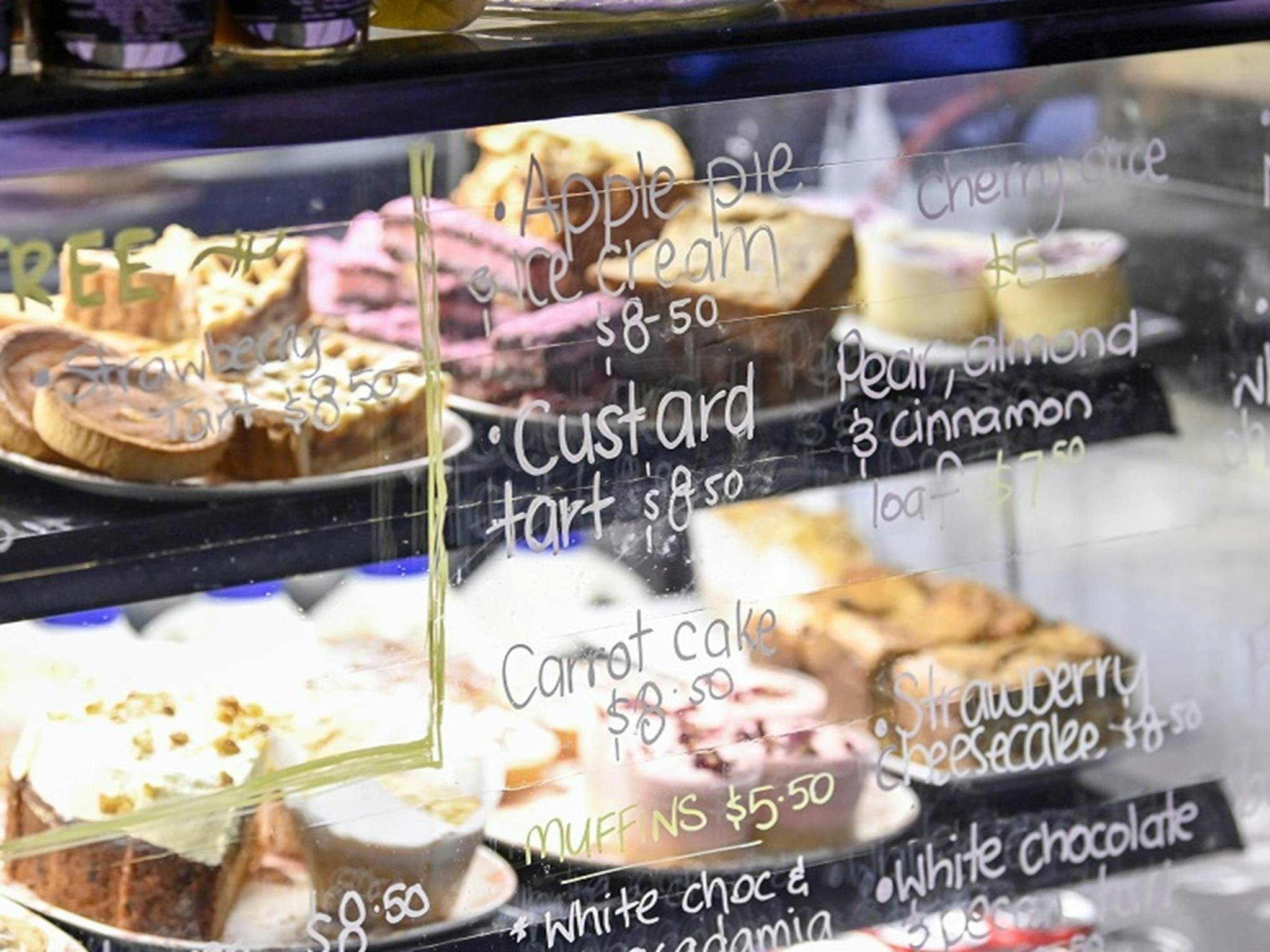 A glass counter with cakes on display at the Rainforest Cafe, Sea Acres National Park. Credit: Adam