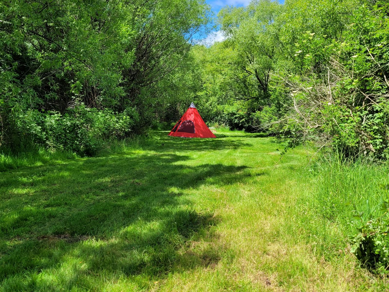 Small Campsite area with Teepee Shaped Tent set up