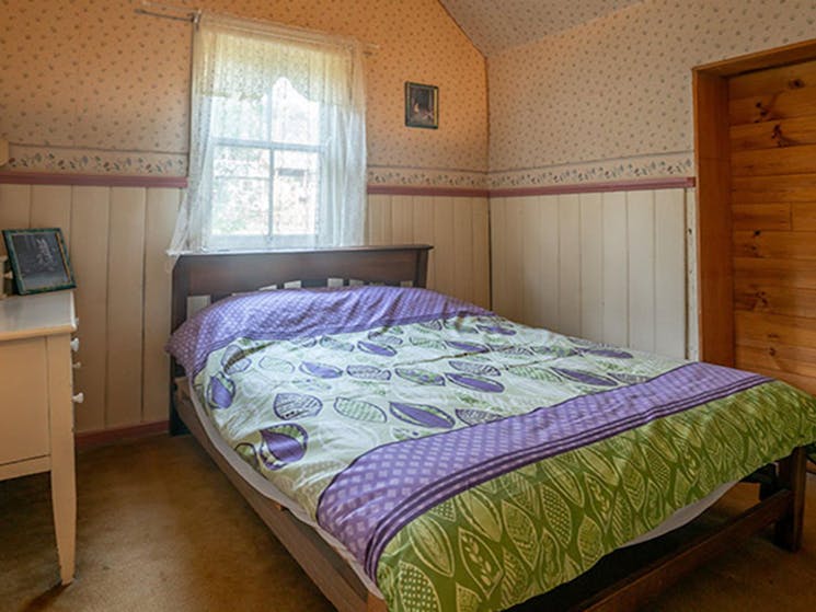 The master bedroom with a double bed at Slippery Norris Cottage in Yerranderie Regional Park. Photo: