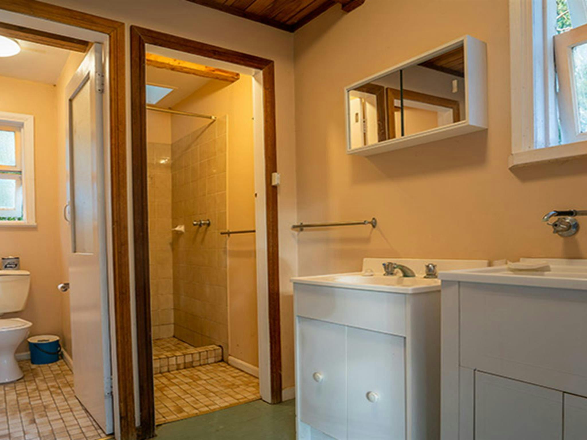 A toilet, shower, basin and laundry tub at Slippery Norris Cottage in Yerranderie Regional Park.