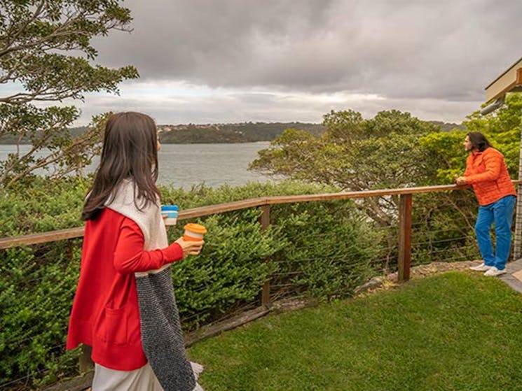 Guests enjoying views of the Sydney Harbour foreshore from the secluded Steele Point Cottage. Photo: