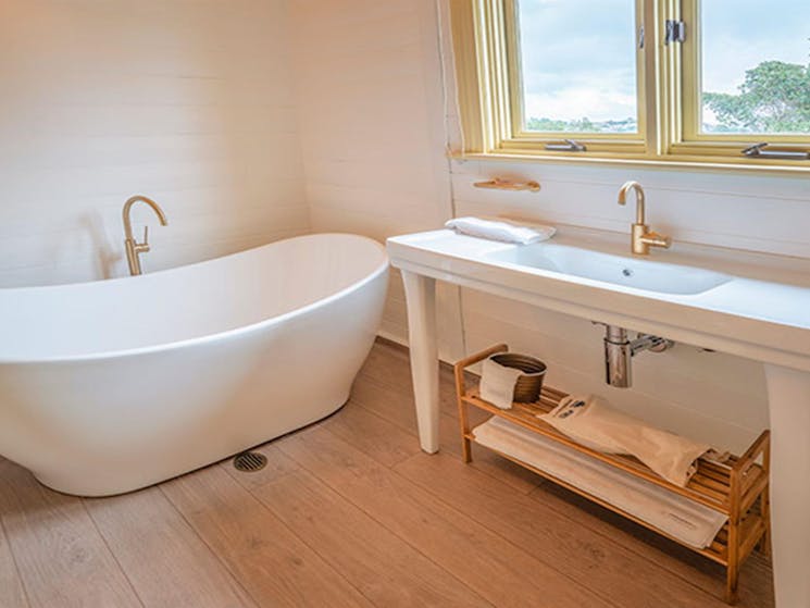 Curved bath and sink in the bathroom at Steele Point Cottage. Photo: John Spencer/OEH