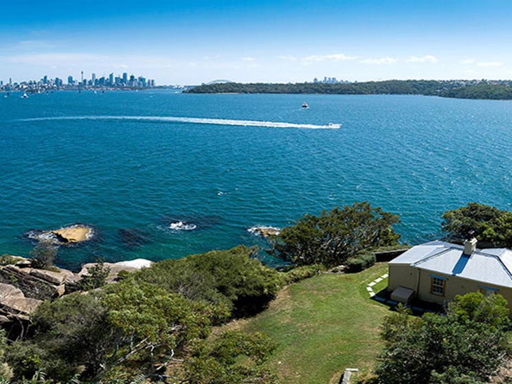 Aerial view of Steele Point Cottage at Vaucluse in Sydney Harbour National Park, with city skyline