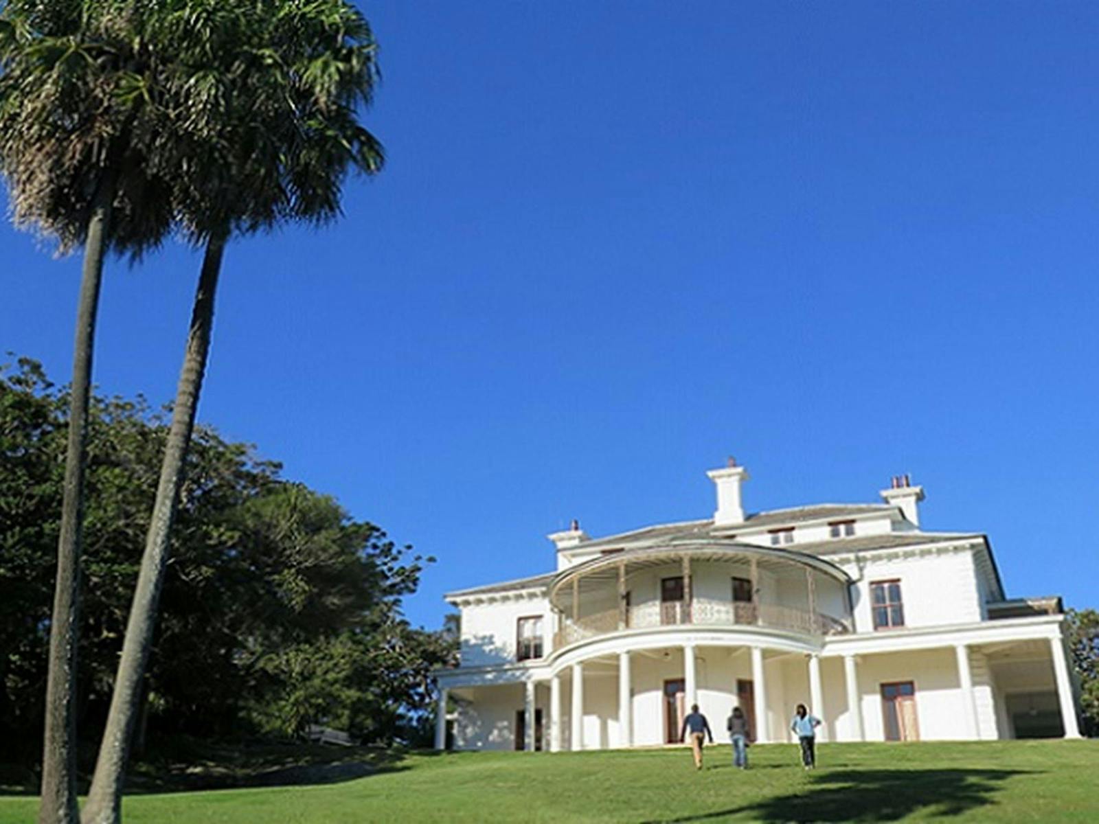 People walking up the lawn to Strickland House, Sydney Harbour National Park. Photo: Elinor