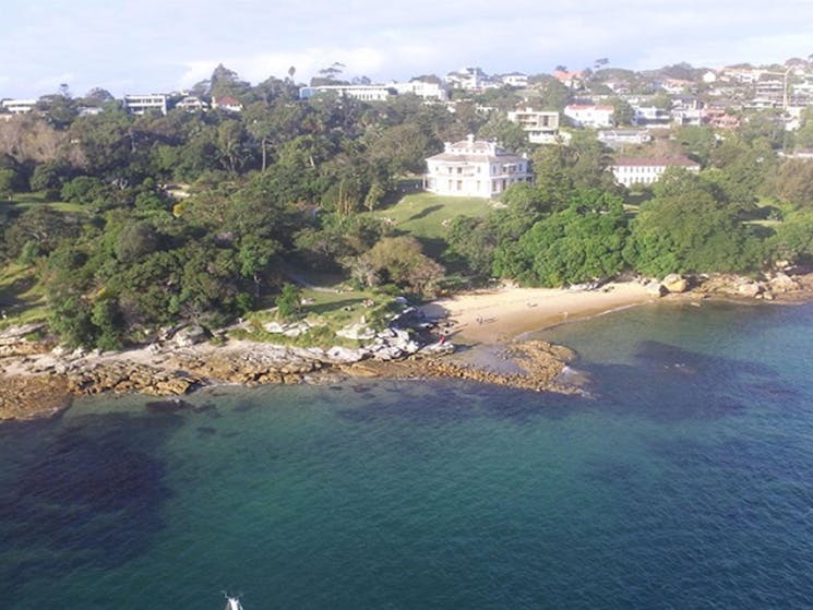 Aerial view showing the harbour foreshore, Milk Beach and Strickland Estate and Carrara House,