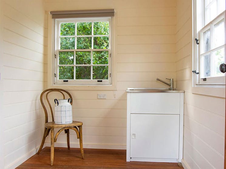 The laundry at Sydney Hotel Cottage with washtub and chair in Hill End Historic Site. Photo: Steve