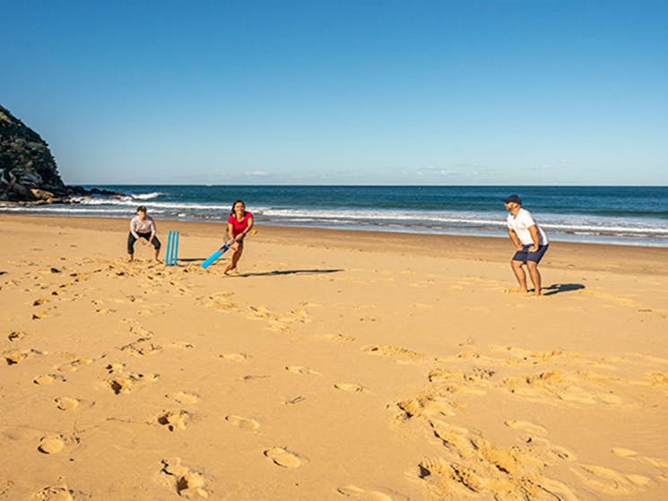 People playing a game of cricket along Tallow Beach, Bouddi National Park. Photo: John Spencer/DPIE.