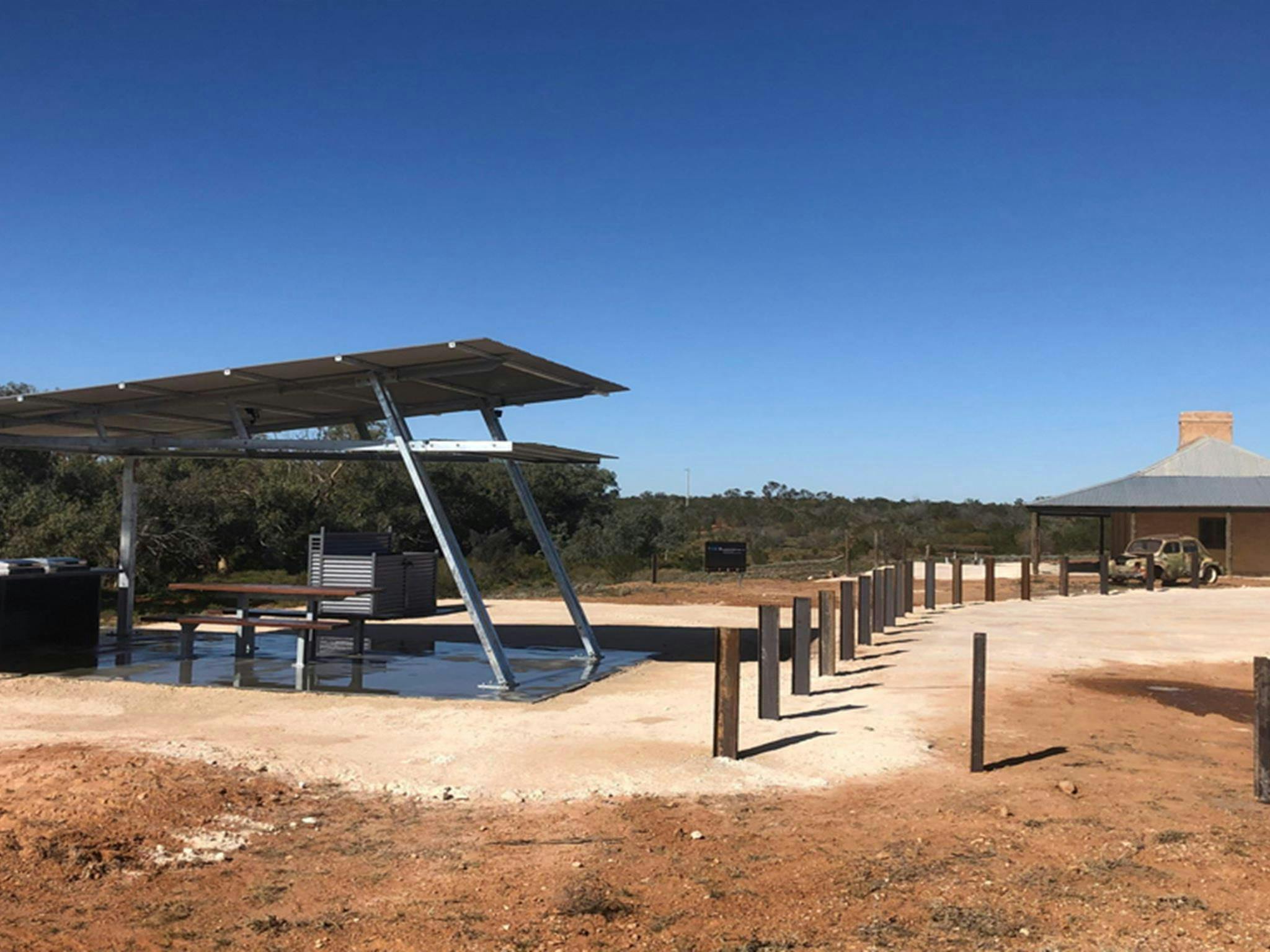 Picnic tables and barbecue under a shelter at Teilta campground and picnic area. Photo &copy; DPE