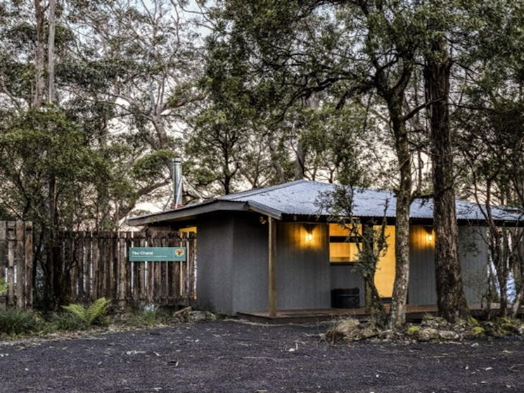 The front exterior of The Chalet surrounded by trees in New England National Park. Photo: Mitchell