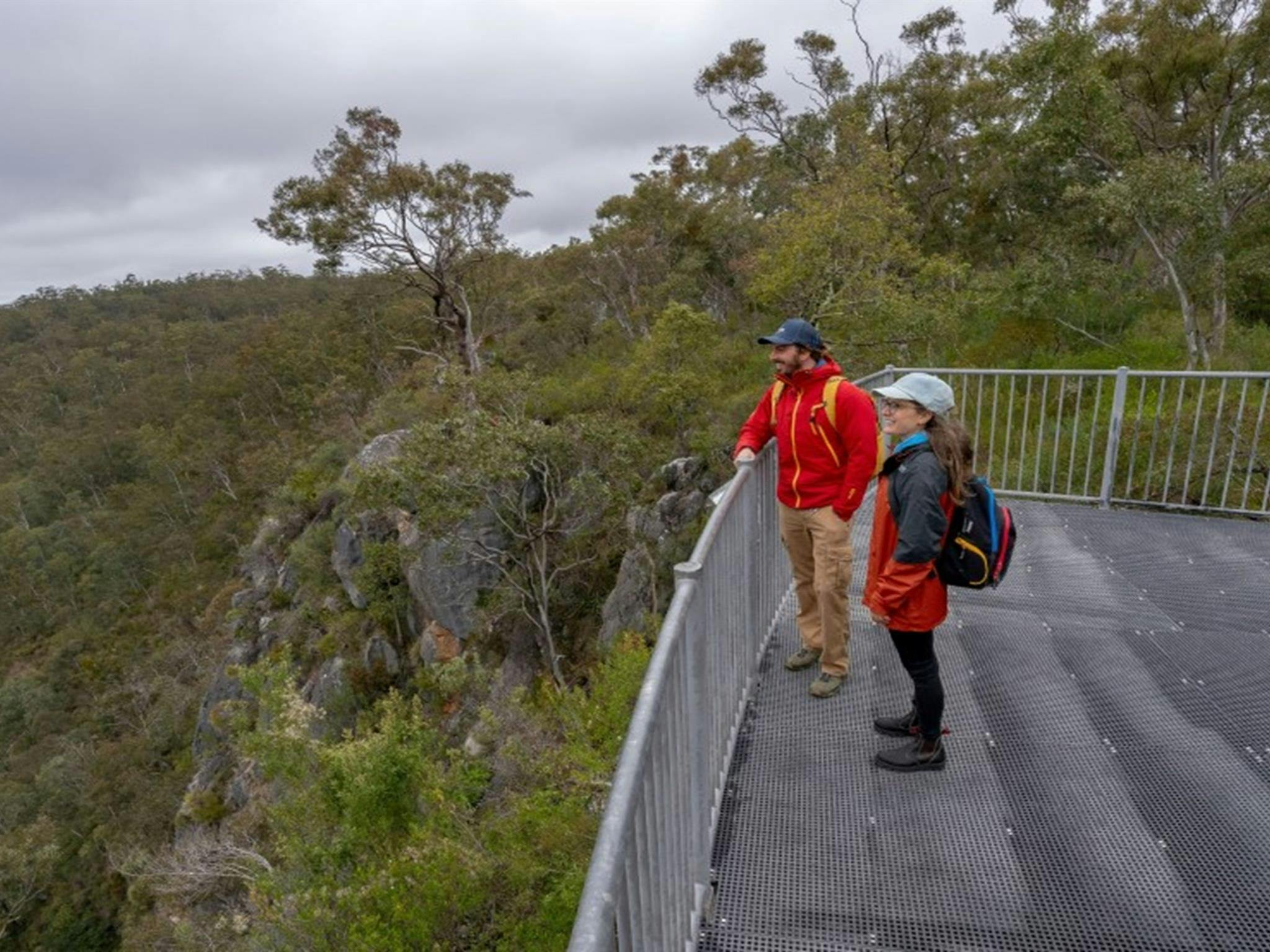 Two people taking in the view from The Lookdown lookout in Bungonia National Park. Photo: John