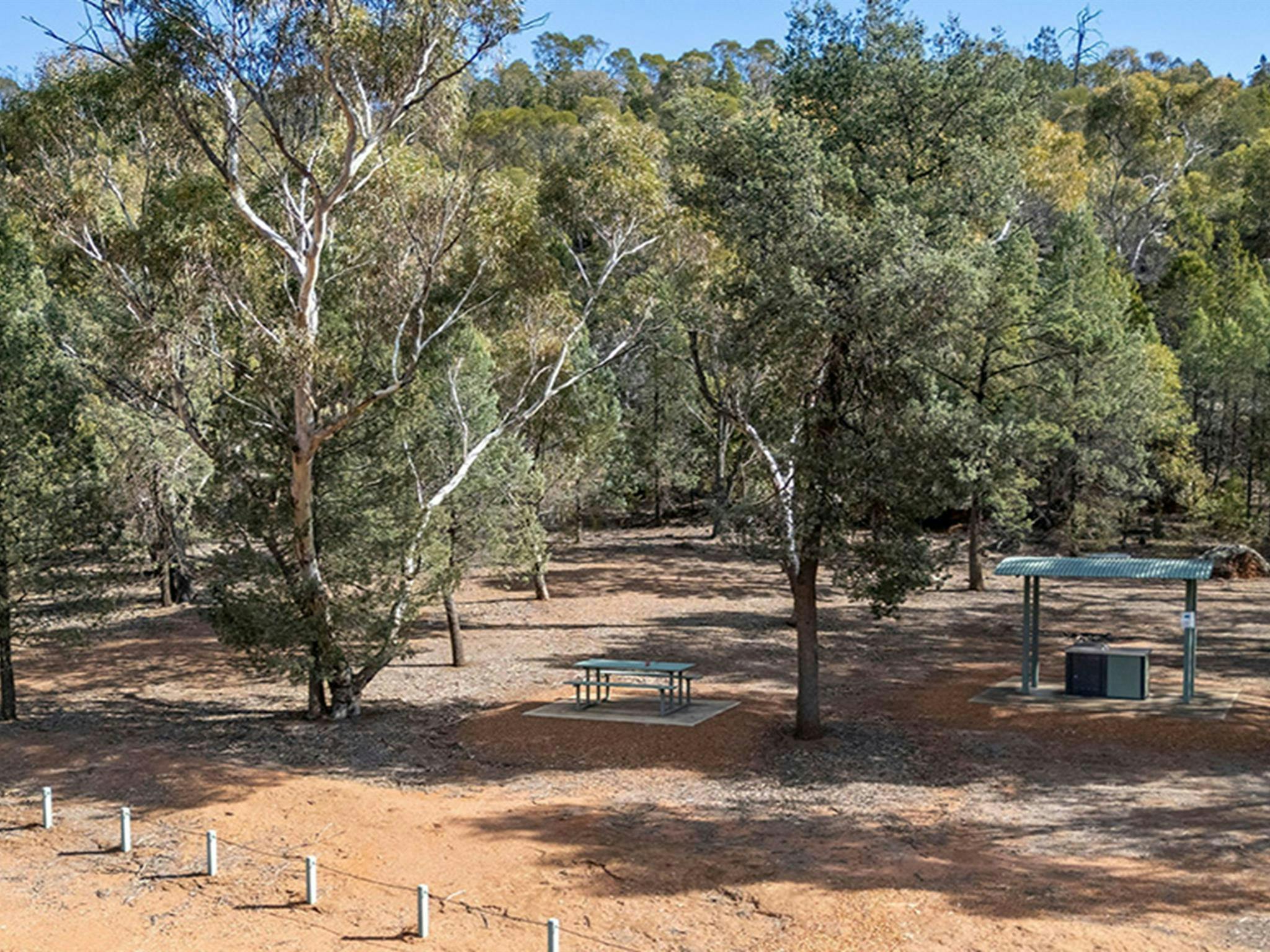 Picnic table and barbecue at The Pines picnic area in Cocoparra National Park. Credit: John Spencer