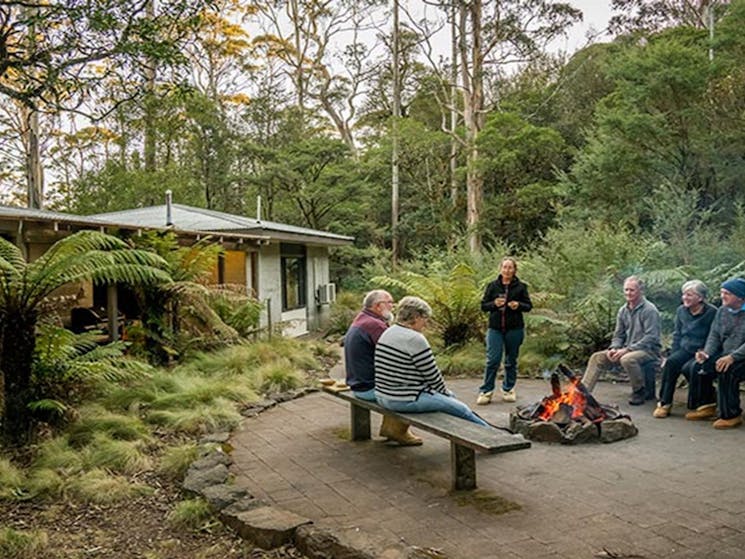 Group of friends sititng around the fire pit at The Residence in New England National Park. Photo: