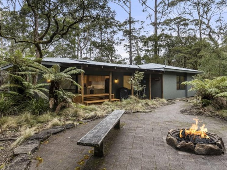 The exterior of The Residence with benches and a fire pit, in New England National Park. Photo: