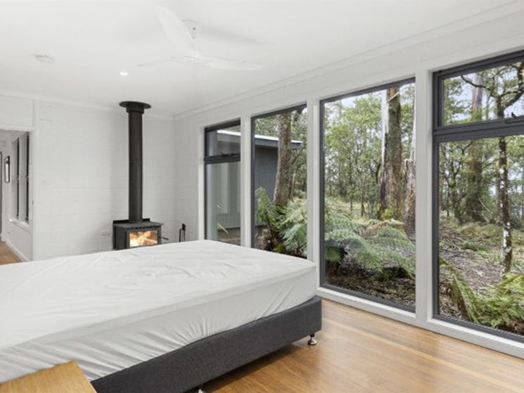 A bedroom at The Residence with views of the surrounding bushland in New England National Park.