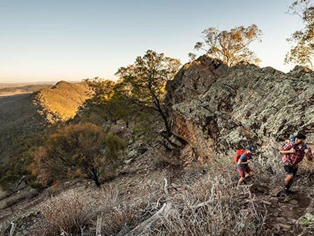 Two men hike uphill along Yerong walking track in The Rock Nature Reserve - Kengal Aboriginal Place.
