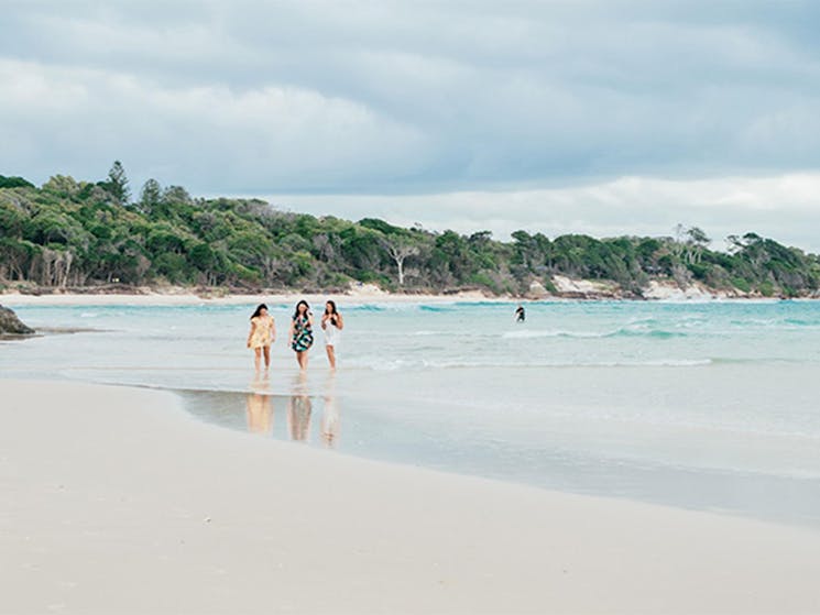 3 friends walking on the beach near Thomson Cottage. Photo: Sera Wright &copy; DPIE
